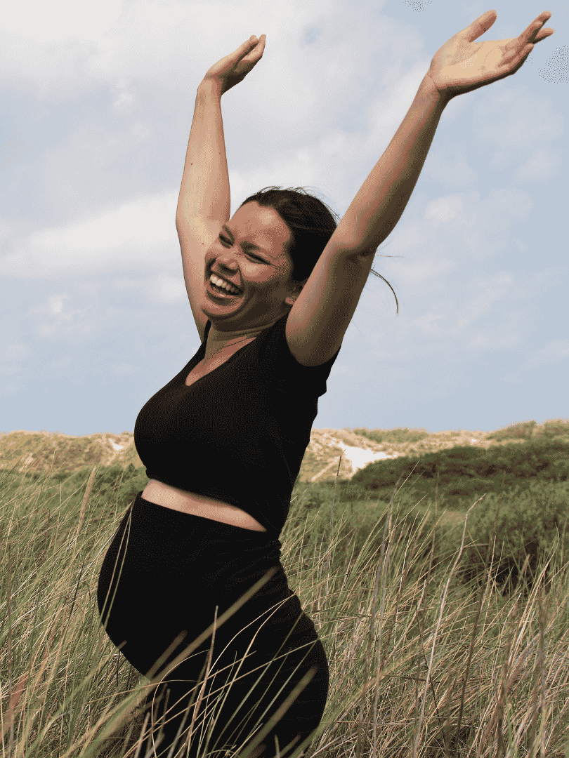 Pregnant woman with arms raised